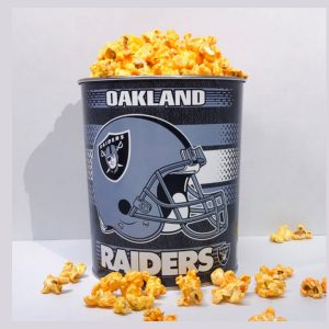 Oakland Raiders popcorn tin full of popcorn sitting on a white table