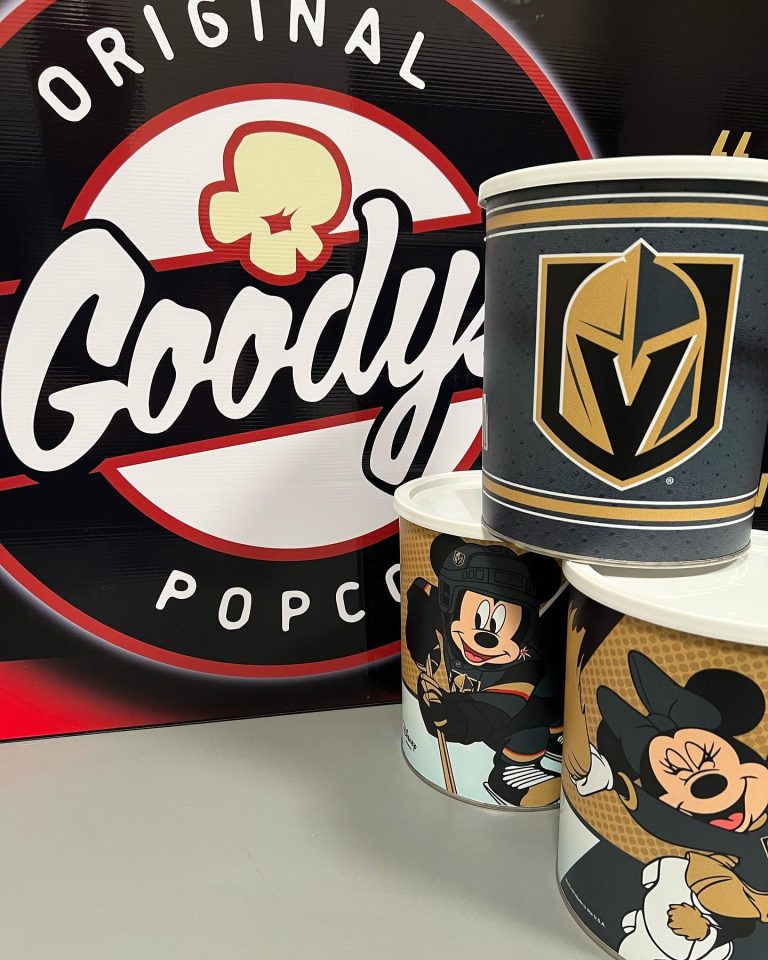Goody's custom popcorn tins in front of a Goody's original popcorn sign